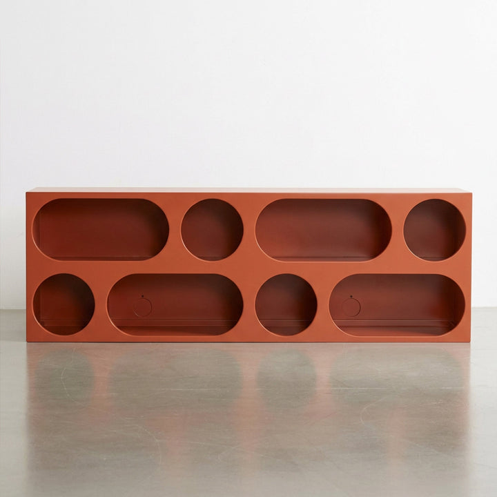 Mueble modular Ebba en color rojizo, con diseño rectangular y compartimentos abiertos, ideal para almacenamiento y exhibición.