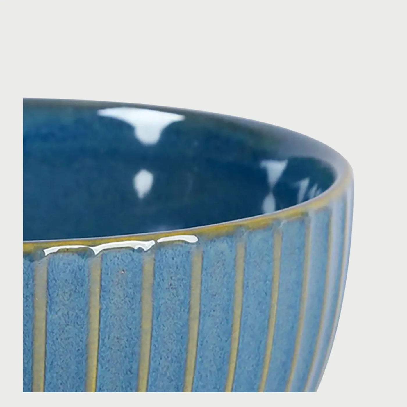 Acercamiento a la textura exterior del bowl Acocota azul; se aprecia el acabado esmaltado brillante y el contraste entre el azul de la pieza y las líneas de relieve claras, que aportan una sensación táctil y visual orgánica.