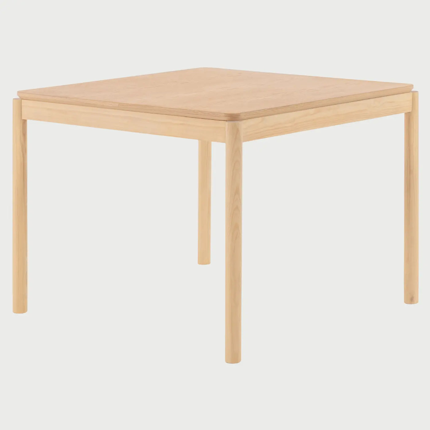 Vista lateral de la mesa Akari de 100 cm; se observa el perfil limpio de la cubierta y la alineación de las patas cilíndricas, resaltando su diseño minimalista y compacto para espacios reducidos.
