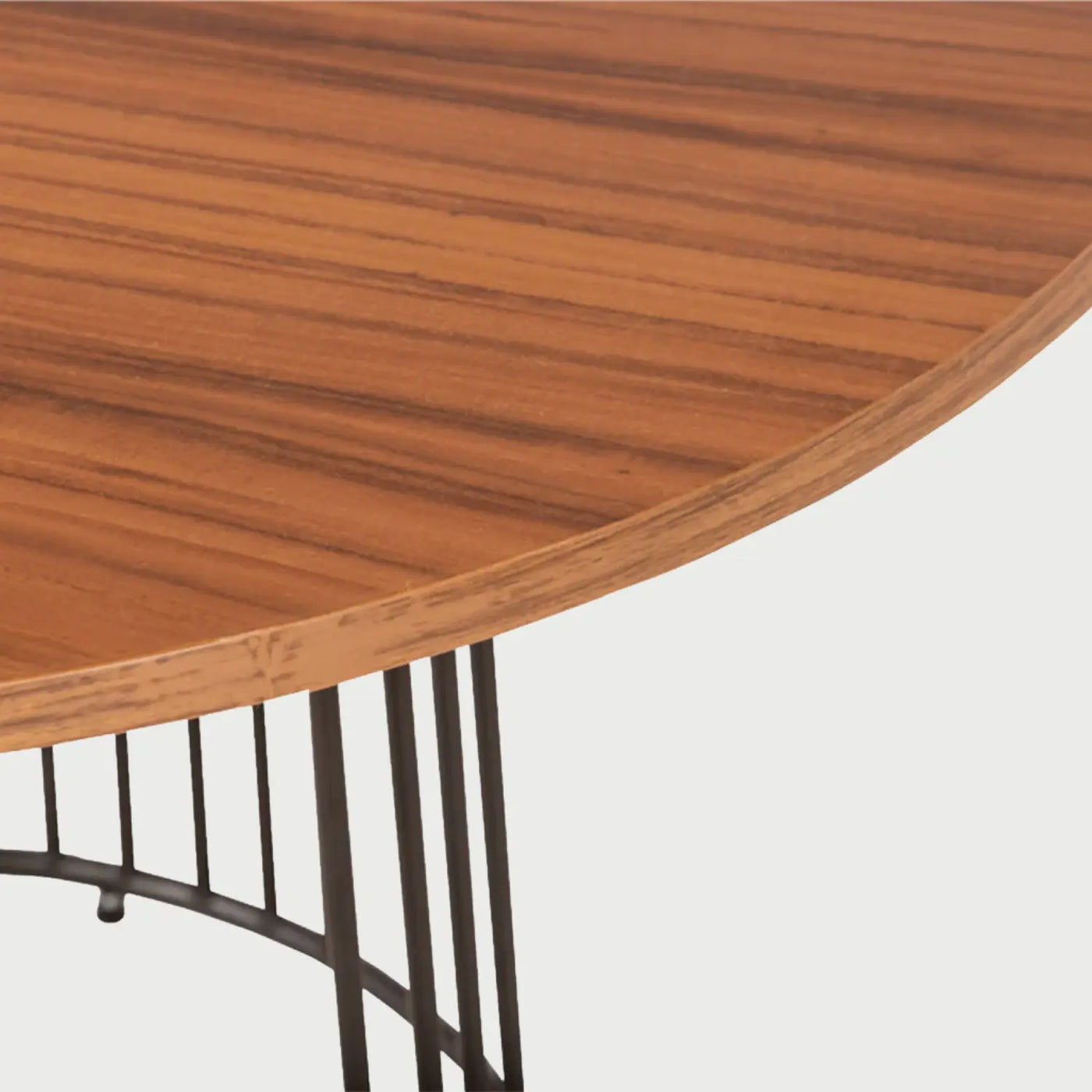 Detalle de la estructura inferior de la mesa Loreta; muestra la base de herrería formada por varillas verticales delgadas que convergen en un anillo circular en el piso, creando un diseño ligero y moderno.