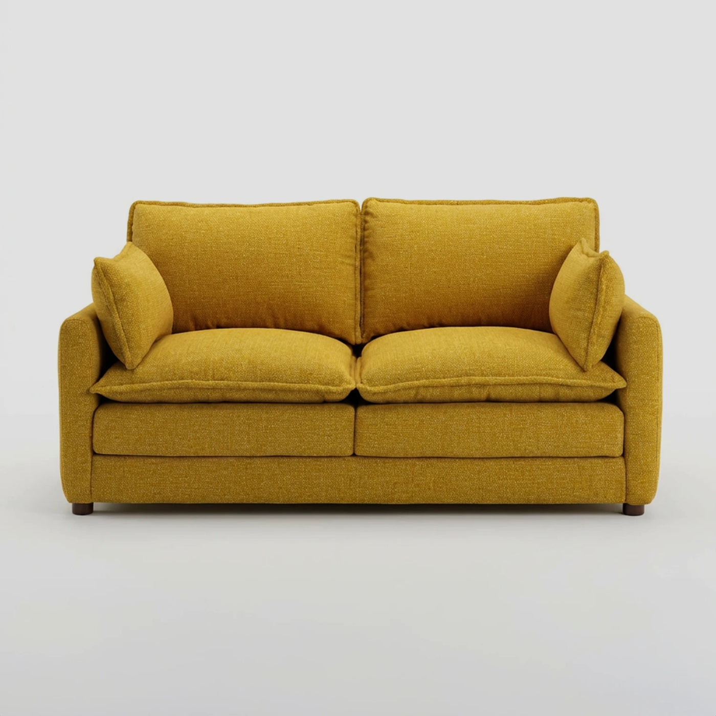 Vista frontal del sofá Andrea de dos cuerpos en color amarillo vibrante, ideal como pieza de acento central por su diseño voluminoso y color alegre.