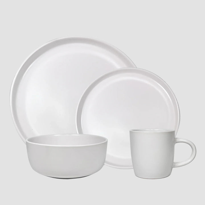 Set de vajilla de cerámica blanca para 4 personas, que incluye dos platos, un tazón y una taza, con un diseño moderno y simple.
