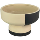 Maceta redonda Monroiva con base pedestal, en tonos beige claro y negro, ideal para plantas o decoración.
