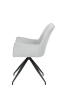 Silla de comedor Caborca con tapizado gris claro y base negra, diseño moderno con respaldo curvado y reposabrazos.
