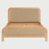 Vista frontal de la cama Queen Size Iki; presenta una estructura robusta de madera clara con esquinas redondeadas y paneles acolchados en color beige tanto en la cabecera como en el pie de cama, ofreciendo una estética orgánica y serena.