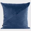 Vista frontal del cojín Bunek de 50 x 50 cm en color azul; presenta el característico patrón de costuras lineales y relieve acolchado sobre terciopelo, ideal para aportar profundidad y sofisticación a la decoración.