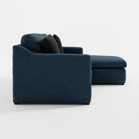 Vista de perfil de la esquinera derecha Marie GAIA en color azul, mostrando la extensión del chaise longue hacia el lado derecho y el diseño de los cojines de asiento acolchados.