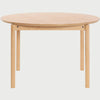 Vista frontal de la mesa de comedor redonda Akari de 120 cm; cuenta con una superficie circular de madera de encino en tono beige y cuatro patas cilíndricas robustas que ofrecen un soporte estable y minimalista.