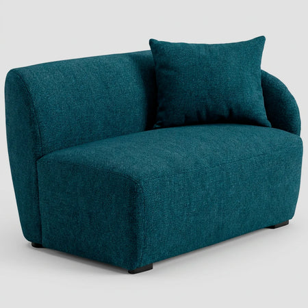 Vista lateral del módulo Kant azul, mostrando el perfil redondeado del brazo derecho y la continuidad de su estructura moderna y acolchada.