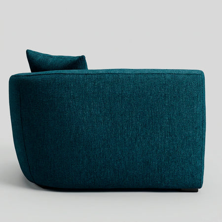 Vista posterior del módulo lateral derecho Kant en azul, resaltando el tapizado uniforme del respaldo curvo que permite lucirlo desde cualquier ángulo.