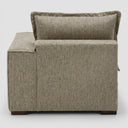 Vista posterior del módulo derecho Emilia en tela gris, resaltando el tapizado liso y la estructura baja que permite una integración fluida con otros módulos.