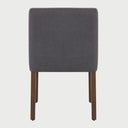 Vista posterior de la silla de comedor Talpa en color gris, resaltando el tapizado liso y uniforme en el reverso del respaldo y la estructura firme de las patas traseras.