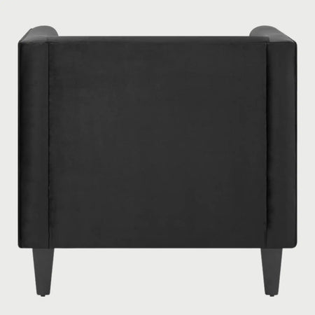 Vista posterior del sillón Moncayo GAIA en terciopelo negro, resaltando el tapizado liso y continuo del respaldo que mantiene una estética minimalista y lujosa desde cualquier ángulo.
