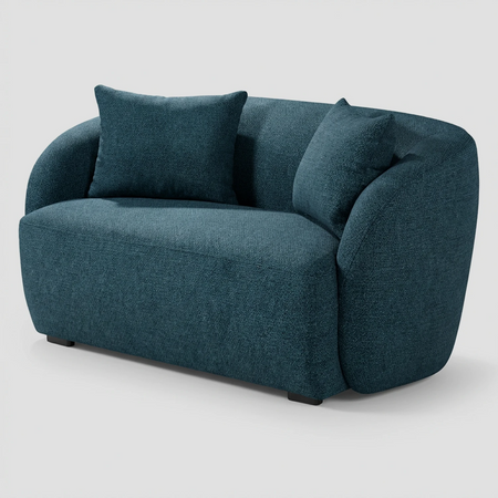 Vista lateral del sillón XL Kant azul, resaltando el perfil curvo y continuo del respaldo hacia los brazos y la profundidad de su asiento acolchado.