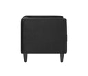 Sillón Moncayo tapizado en terciopelo negro, con diseño minimalista y patas visibles, ideal para cualquier sala.