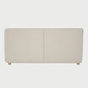 Vista posterior del sofá cama Basil en color blanco, mostrando el tapizado uniforme y la estructura sólida soportada por patas de madera natural.