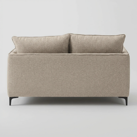 Vista trasera del sofá Cecil; muestra el acabado textil uniforme en color blanco que permite ubicarlo en el centro de una habitación, manteniendo una estética limpia desde cualquier ángulo.