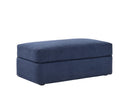 Taburete Amil tapizado en azul, con forma rectangular y superficie suave, ideal para cualquier espacio.